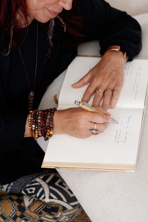 Dawn’s hands writing in a journal